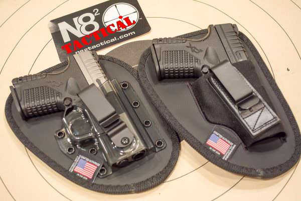 A pair of N82 Tactical Holsters. On the left is the retention model with polycarbonate shell. On the right is a tuckable Original model. 