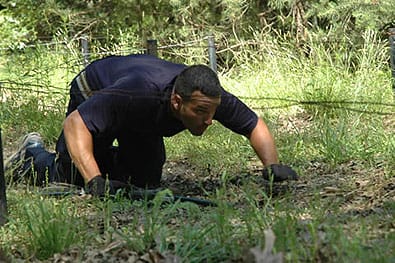 Kenny Schiattarella of the Ocean County, New Jersey SWAT team rapidly makes his way under the low-crawl wires during the Obstacle Course and Movement event at the 2008 FNH USA - Leupold Long Range Precision Shooting Competition at Ft. Meade, Maryland. FNH USA Photo.