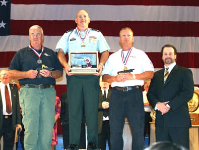 CAMP PERRY, Ohio--Sgt. 1st Class James Henderson (center), is applauded after being named the 2009 National Pistol Champion July 18. Henderson is the first active-duty Soldier to win the top prize since 1985. (Photo by Michael Molinaro, USAMU PAO)