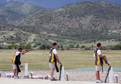 COLORADO SPRINGS, CO.--Spc. Jeff Holguin (left), U.S. Army Marksmanship Unit, shoots on a target as teammates Staff Sgt. Josh Richmond (center) and Sgt. 1st Class Bill Keever (right) look on. All three USAMU shooters took part in the finals of the double trap event at the U.S. National Shotgun championships July 13. Richmond bested the field, claiming the gold medal and Holguin took the silver. (Photo by Michael Molinaro, USAMU PAO)