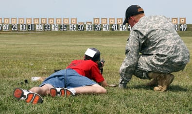 CAMP PERRY, Ohio--Nathan Baldwin, 14, concentrates on his target during a live-fire exercise Aug 1. He is being instructed on the M16A2 by Spc. Evan Hess, U.S. Army Marksmanship Unit. Soldiers from the USAMU conducted the 2009 Small Arms Firing School, teaching novice shooters the efficient application of the fundamentals of marksmanship. (Photo by Michael Molinaro, USAMU PAO)