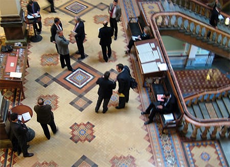 IGO Executive Director Aaron Dorr (at middle right holding yellow petitions) speaks to Senator Gronstal.