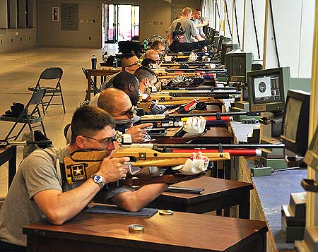 FORT BENNING, Ga.--Wounded warrior Soldiers conduct a practice match under the tutelage of Soldiers from the U.S. Army Marksmanship Unit Apr. 1 at Pool Indoor Range. They are training for the inaugural Warrior Games, slated to be held May 10-14 at the Olympic Training Center in Colorado Springs, Colo. (Photo by Michael Molinaro, USAMU PAO)