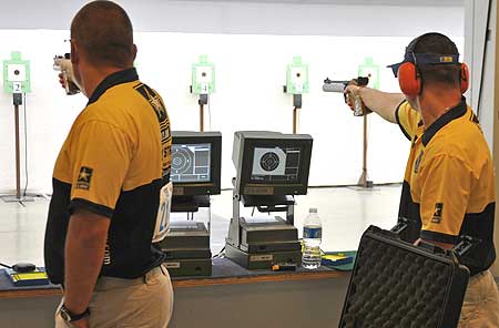 FORT BENNING, Ga. -- Sgt. 1st Class Daryl Szarenski and Pfc. Greg Markowski, U.S. Army Marksmanship Unit, compete in the Men's Air Pistol final June 15 at Pool Indoor Range during the U.S. National Rifle and Pistol Championships. Szarenski won the gold medal and national championship, and was followed by Markowski. They duplicated their effort in Men's Free Pistol a few days later. (Photo by Michael Molinaro, USAMU PAO) 