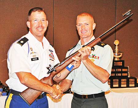 MARINE CORPS BASE QUANTICO -- Staff Sgt. Brandon Green, U.S. Army Marksmanship Unit, is presented a Trophy Rifle by Lt. Col. Daniel Hodne, commander, USAMU, after winning the individual championship at the 49th Interservice Rifle Championship. Green won six individual titles and was a member of three first-place teams. (Photo by Michael Molinaro, USAMU PAO)