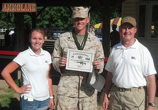 Sgt. Nicholas Carson, USMC, the Third Annual Quantico Combat Shooting Match champion, receiving his certificate for a Colt Defense M4 Carbine (l to r, Jessica Livingston, Colt Defense Sales; Sgt. Nick Carson, USMC; Roger Smith, Colt Defense Washington Operations).