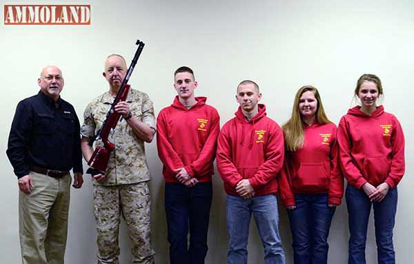 Mark DeBoard, Shooting Service Manager at Crosman Corporation, presents the winning sporter team, R-S Central HS MCJROTC from Rutherfordton, NC, with a new red Crosman air rifle. Team members are Baylee Boone, Spencer White, Jesse Bradley and Taylor Wease and Coach Major Russell Armentrout.