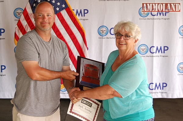 Mark Aussieker, 44, of Wenona, IL, was the overall leader in the National Springfield Match, with a score of 294-7x. Mrs. Judy Legerski, Chairman, CMP Board of Directors, presented Mark with his trophy plaque.