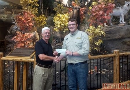 Mike Christensen is shown receiving the check from Bradley Harting, Marketing Manager for the Cabela's store in Wichita.