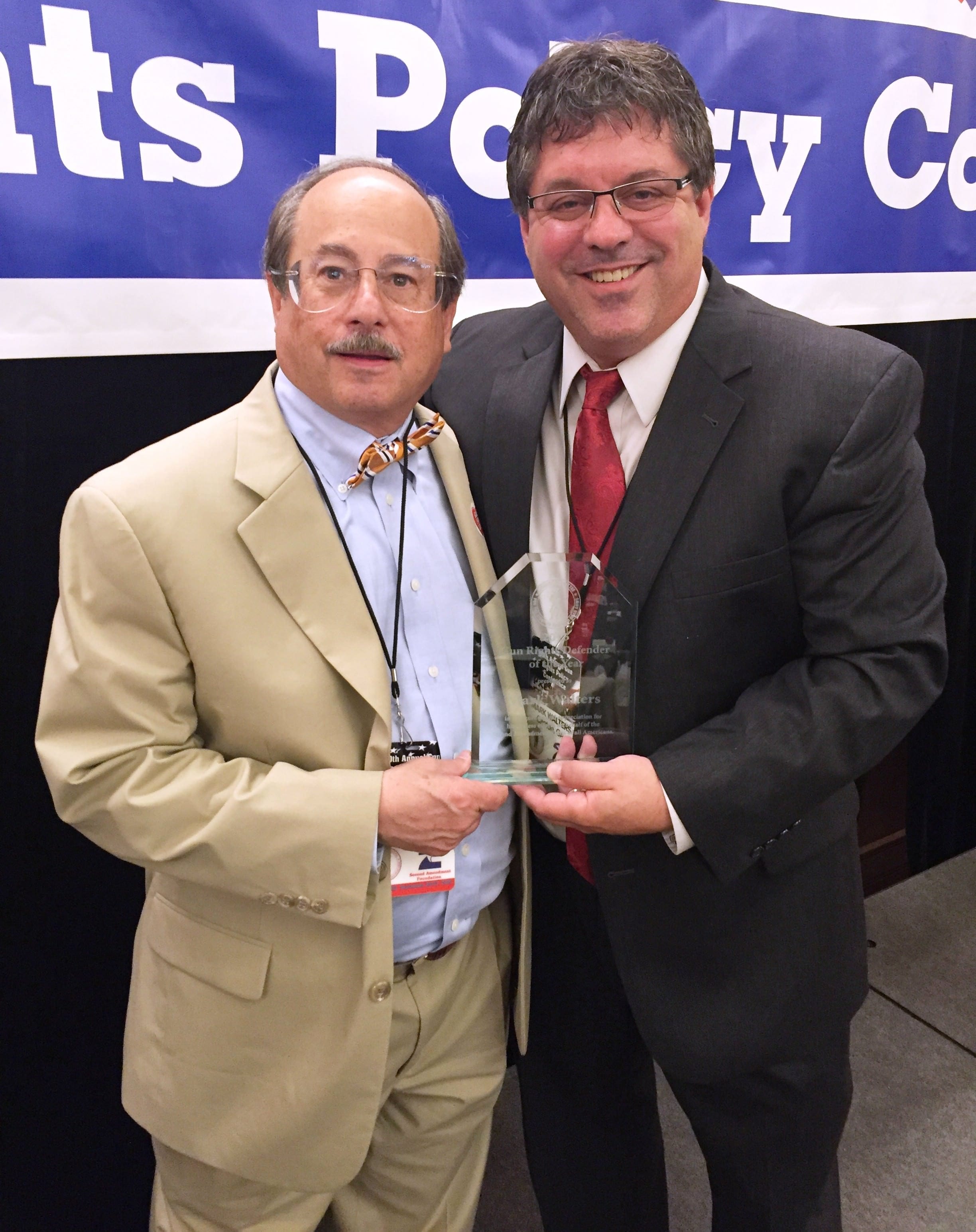 Second Amendment Foundation Executive Director, Alan Gottlieb (left) presents the Gun Rights Defender of the Year Award to Armed American Radio host Mark Walters