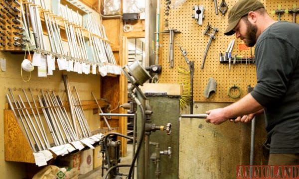 Maverick McCourt prepares to install a rifle barrel on a receiver using Pac-Nor’s barrel press.