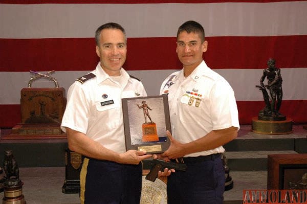 Colonel Anthony Digiacomo, USA, presents PFC Christopher Hudock, USA with the 2016 General Custer Trophy and an Inland Manufacturing 1911 A1 pistol