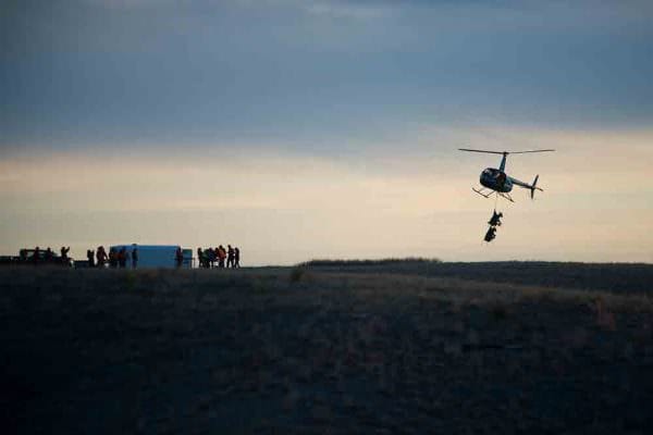 The helicopter arrives at the processing site near Chadron State Park with two ewes. (NEBRASKAland/Justin Haag)