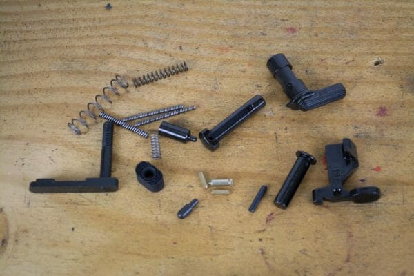 You'll need a lower parts kit with latches, pins, and springs. We got one without a trigger group because Brownells provided a Geissele trigger set.