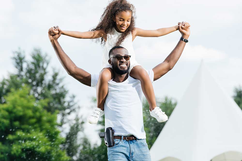 Happy Gun Owner With Daughter On Shoulders