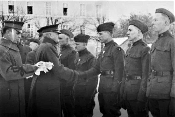 Army Gen. John Pershing shakes hands with Medal of Honor recipient Pfc. Charles Barger after awarding him the honor at his headquarters in Chaumont, France, on Feb. 7, 1919.