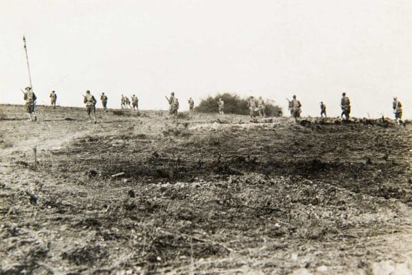 Troops of the 64th Infantry Brigade, 32nd Division, advancing near Romagne-Sous-Montfaucon, Meuse, France, Oct. 18, 1918.