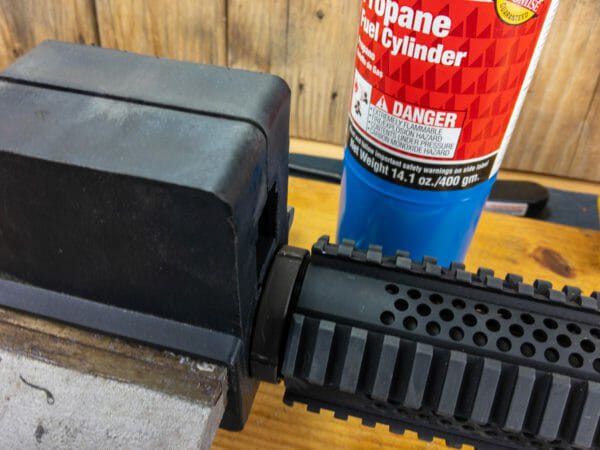 How to Install or Change Your AR Handguard - Featuring the Brownells Wrenchman: This Rock River handguard was mounted with a counter-rotating locking ring. I had to, umm, blowtorch it a bit, then bash it loose with a hammer and screwdriver. Or you could use an appropriate spanner wrench but I didn't have one.