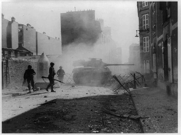 A U.S. Army tank destroyer M36 fires its 90mm gun point-blank at a Nazi pillbox emplacement to clear a path through a side street in Brest, France, September 1944.