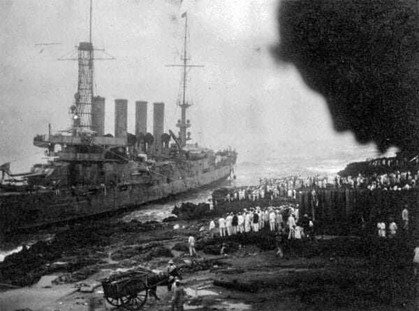 The USS Memphis the day after it was wrecked during a tropical disturbance as it sat anchored off the coast of Santo Domingo City in the Dominican Republic. The lines coming from the ship to the shore were used during the rescue of the crew. 