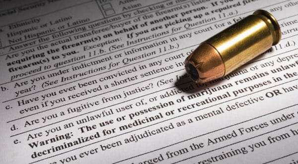 NICS Background Check Marijuana Exclusion ATF Form 4473 Firearms Transaction Record Question. iStock-919659526