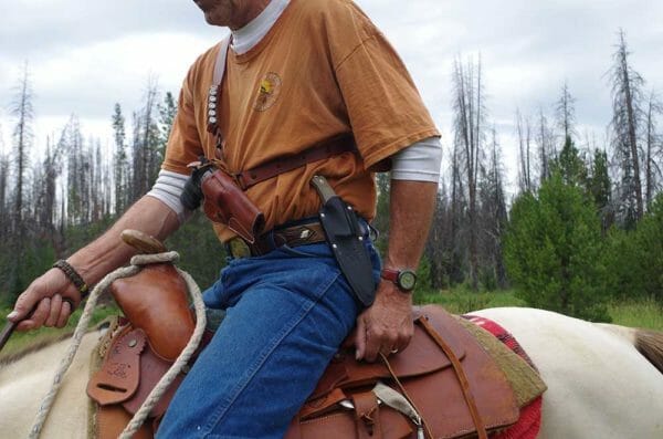 You can see that the Diamond D holster holds your pistol firmly in place. A leather throng over the hammer keeps it from slipping out. The belt also has loops for 6 more rounds.