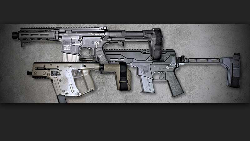 Three stabilizing races attached to machine guns laying on a table Image ATF-gov