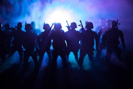 IRS ATF World War Soldiers Silhouettes Below Cloudy Skyline At night. Attack scene iStock-Zeferli 943797468