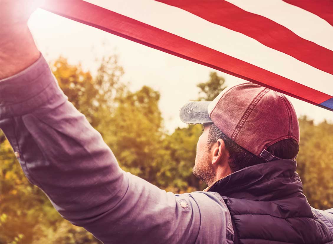 patriotic man flag iStock-Sviatlana Barchan 1153252050