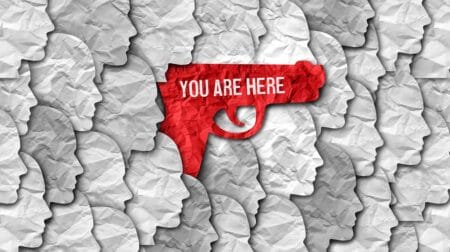 iSTOCK AI red hand gun crowd concealed carry open armed pistol iStock-wildpixel 1439374079.jpg