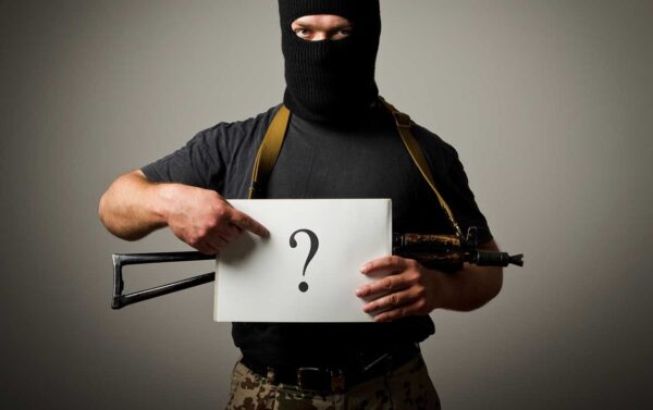 Poling Survey Gunman is holding white paper with question-mark iStock-maurusone 512100997.jpg